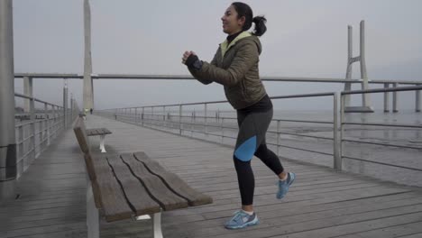 Smiling-hindu-woman-training-on-wooden-pier